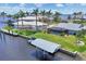 Waterfront home with a boat dock, lift, and scenic backyard views of the adjacent property at 3025 Curry Ter, Port Charlotte, FL 33981