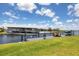 Dock with a boat lift and scenic water view of the nearby property and easy access to the waterfront at 3025 Curry Ter, Port Charlotte, FL 33981