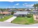 Charming single-Gathering home with lush lawn, mature landscaping, and a two-car garage in a waterfront community at 3025 Curry Ter, Port Charlotte, FL 33981