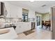 Modern kitchen featuring white cabinetry, stainless steel appliances, tile backsplash, and durable countertops at 3025 Curry Ter, Port Charlotte, FL 33981