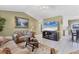 Comfortable living room with tile flooring, neutral walls, ceiling fan, comfortable seating, and a view to kitchen and dining area at 3025 Curry Ter, Port Charlotte, FL 33981