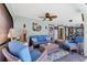 Cozy living area with comfortable seating, nautical decor, and access to the pool, perfect for relaxation and entertaining guests at 3025 Curry Ter, Port Charlotte, FL 33981