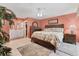 Inviting main bedroom featuring a floral bedspread, ensuite bathroom, and neutral tones at 3025 Curry Ter, Port Charlotte, FL 33981