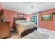 Comfortable main bedroom with floral bedding and sliding glass doors to the outdoors at 3025 Curry Ter, Port Charlotte, FL 33981