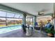 Inviting screened patio overlooking pool and canal featuring comfortable wicker furniture at 3025 Curry Ter, Port Charlotte, FL 33981