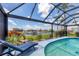 Inviting pool area featuring comfortable lounge seating, well-maintained landscaping, and scenic views for ultimate relaxation at 3025 Curry Ter, Port Charlotte, FL 33981