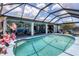 This outdoor pool area with cozy seating, direct access to the living area, and lush greenery provides a seamless indoor-outdoor experience at 3025 Curry Ter, Port Charlotte, FL 33981