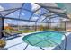Stunning pool with clear water, framed by lush landscaping, and expansive views, creating a serene and private retreat at 3025 Curry Ter, Port Charlotte, FL 33981