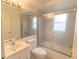 Bathroom featuring a shower over tub with sliding glass doors, vanity and toilet at 407 Park S Blvd, Venice, FL 34285