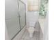 The bathroom has a toilet, shower/tub with sliding glass doors, and a sink with vanity at 407 Park S Blvd, Venice, FL 34285