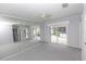 Bedroom with light gray walls, carpet, ceiling fan, and access to the patio area with a hot tub at 407 Park S Blvd, Venice, FL 34285