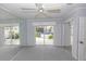 Bedroom with access to the patio and hot tub, mirrored closet, ceiling fan, and gray walls at 407 Park S Blvd, Venice, FL 34285