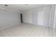 Spacious bedroom featuring tiled floors, neutral walls, and ample closet space with room to customize at 407 Park S Blvd, Venice, FL 34285