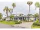 Single story home with manicured landscaping, palm trees, and a covered, screened-in porch at 407 Park S Blvd, Venice, FL 34285
