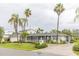 Charming single-story home featuring a lush landscaped yard and tall palm trees providing a tropical feel at 407 Park S Blvd, Venice, FL 34285