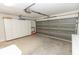 Spacious garage with an automatic door, extra storage cabinets, and ample space for vehicles and tools at 407 Park S Blvd, Venice, FL 34285