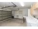 A spacious garage featuring laundry hookups, cabinets, and garage door at 407 Park S Blvd, Venice, FL 34285
