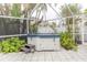 Hot tub surrounded by lush tropical landscaping in screened in lanai at 407 Park S Blvd, Venice, FL 34285