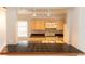 View of kitchen with dark countertops, stainless steel appliances, and light wood cabinets at 407 Park S Blvd, Venice, FL 34285
