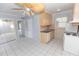 Kitchen featuring tiled floors, wood cabinets and a sink, stove, and a dishwasher at 407 Park S Blvd, Venice, FL 34285