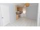 Functional kitchen featuring tiled floors, white appliances and light wood cabinets with an adjacent dining area at 407 Park S Blvd, Venice, FL 34285