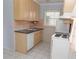 Kitchen features a window over the sink, tan cabinets, and a white oven at 407 Park S Blvd, Venice, FL 34285