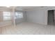 Bright and airy living room with tiled floors, large windows, and convenient access to the stairs at 407 Park S Blvd, Venice, FL 34285