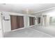 Carpeted main bedroom with ceiling fan, large mirror feature wall and neutral paint at 407 Park S Blvd, Venice, FL 34285