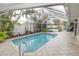 Screened in pool and patio area featuring tropical plants and a hot tub at 407 Park S Blvd, Venice, FL 34285