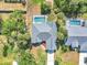 Aerial view of a home with a screened-in pool and well-maintained landscaping at 4210 Day St, Port Charlotte, FL 33948