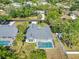Aerial view of a beautiful home with a screened-in pool surrounded by lush landscaping at 4210 Day St, Port Charlotte, FL 33948