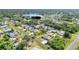 An aerial view of a residential area, highlighting houses with swimming pools and lush landscaping near a lake at 4210 Day St, Port Charlotte, FL 33948