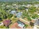 An aerial shot showcases a neighborhood with lush greenery, swimming pools, and well-maintained homes at 4210 Day St, Port Charlotte, FL 33948