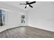 Bright bedroom featuring luxury vinyl floors, ceiling fan and oversized windows at 4210 Day St, Port Charlotte, FL 33948