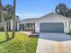 Well-maintained one story home with a driveway leading to an attached garage and a welcoming entrance at 4210 Day St, Port Charlotte, FL 33948
