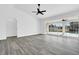 An airy living room features new floors, sliding glass doors, and a ceiling fan at 4210 Day St, Port Charlotte, FL 33948