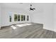 Bright, spacious living room featuring hardwood floors and a large bay window at 4210 Day St, Port Charlotte, FL 33948