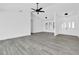 Spacious, bright living area with sleek flooring and a modern ceiling fan, perfect for entertaining at 4210 Day St, Port Charlotte, FL 33948