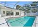 Backyard view showcasing an in-ground pool with an enclosed screen at 4210 Day St, Port Charlotte, FL 33948