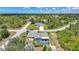 Aerial view of a home with a screened pool and lanai surrounded by lush landscaping at 4510 Burns Ter, Port Charlotte, FL 33981