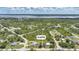 Aerial shot showcasing the large lot with a primary home, pool, outbuilding, and oversized garage close to the water at 4510 Burns Ter, Port Charlotte, FL 33981