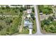 Aerial view of house on large lot with pool, outbuilding, putting green and large 30x28 garage at 4510 Burns Ter, Port Charlotte, FL 33981
