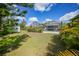 Spacious backyard features lush grass, tropical plants, a large screen-enclosed lanai and storage shed at 4510 Burns Ter, Port Charlotte, FL 33981
