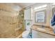 Tiled bathroom featuring a shower with glass doors, granite counters, and neutral colors at 4510 Burns Ter, Port Charlotte, FL 33981