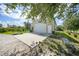 Spacious garage features a concrete driveway with a putting green and yard at 4510 Burns Ter, Port Charlotte, FL 33981