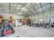 A spacious garage interior with a lawn mower, trailer, bicycles, and shelving for storage at 4510 Burns Ter, Port Charlotte, FL 33981