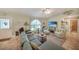 Bright living room with tile flooring, vaulted ceilings, comfortable seating, and a view to the outdoor living spaces at 4510 Burns Ter, Port Charlotte, FL 33981
