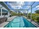 Large screened-in pool area with outdoor seating, ideal for enjoying the Florida sunshine at 4510 Burns Ter, Port Charlotte, FL 33981