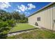 This backyard features a synthetic putting green that sits next to a spacious garage on a large lot at 4510 Burns Ter, Port Charlotte, FL 33981
