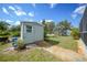 This backyard shed features a ramp, window and is surrounded by lush greenery and trees at 4510 Burns Ter, Port Charlotte, FL 33981